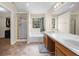 Bathroom featuring a double vanity, soaking tub, and separate walk-in shower with a glass door at 1725 Silverchase Sw Dr, Marietta, GA 30008