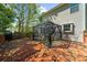 Spacious wooden deck with an outdoor dining area, grill, and access to the backyard at 1725 Silverchase Sw Dr, Marietta, GA 30008