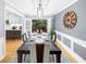 Dining area with seating for six, modern chandelier, and backyard views at 1725 Silverchase Sw Dr, Marietta, GA 30008