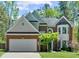 Charming two-story home with a brick facade, manicured lawn, and mature trees at 1725 Silverchase Sw Dr, Marietta, GA 30008
