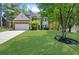 Charming two-story home with a brick facade, manicured lawn, and mature trees at 1725 Silverchase Sw Dr, Marietta, GA 30008