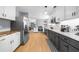 Modern kitchen featuring stainless steel appliances, contrasting cabinets, and hardwood floors at 1725 Silverchase Sw Dr, Marietta, GA 30008