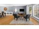 Comfortable living room featuring gray accent wall, hardwood floors, and dining area at 1725 Silverchase Sw Dr, Marietta, GA 30008