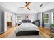 Spacious main bedroom with wood floors, tray ceiling, ceiling fan, and ensuite bathroom access at 1725 Silverchase Sw Dr, Marietta, GA 30008