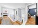 Upstairs hallway featuring hardwood floors, white staircase, and views of bedrooms at 1725 Silverchase Sw Dr, Marietta, GA 30008