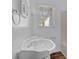 Bathroom features a sink, a mirror, and a window at 272 Colchester Dr, Stone Mountain, GA 30088