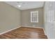 Bedroom features natural light, wainscoting, and wood-look flooring at 272 Colchester Dr, Stone Mountain, GA 30088