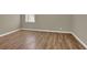 A spacious bedroom features natural light and beautiful wood-look flooring at 272 Colchester Dr, Stone Mountain, GA 30088