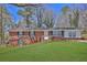 Charming single-story brick home with green shutters and a well-manicured front lawn at 272 Colchester Dr, Stone Mountain, GA 30088