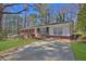 Beautiful ranch-style home with a brick facade, complemented by a long driveway at 272 Colchester Dr, Stone Mountain, GA 30088