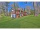 Lovely brick home with a sprawling green lawn, surrounded by mature trees at 272 Colchester Dr, Stone Mountain, GA 30088