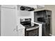 The kitchen features black appliances, and white cabinets at 272 Colchester Dr, Stone Mountain, GA 30088