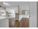 Open-concept kitchen with white cabinets, wood-look flooring, and ample counter space at 272 Colchester Dr, Stone Mountain, GA 30088
