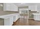 Bright kitchen with white cabinets, featuring a dining area and sliding door access to the patio at 272 Colchester Dr, Stone Mountain, GA 30088