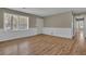 Bright living room with wood-look floors, white wainscoting, and large windows at 272 Colchester Dr, Stone Mountain, GA 30088