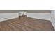 Spacious living room with wood-look floors, neutral walls, and white trim at 272 Colchester Dr, Stone Mountain, GA 30088