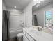 Clean bathroom featuring a shower with gray curtains and a wide mirror over the sink at 3567 Hidden Valley Cir, Lawrenceville, GA 30044