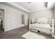 Bright bedroom with a neutral palette, a decorative bed, and a view into the attached bathroom at 3567 Hidden Valley Cir, Lawrenceville, GA 30044