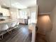 Modern kitchen features an island with seating, stainless steel appliances, and a staircase at 3567 Hidden Valley Cir, Lawrenceville, GA 30044