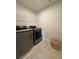 Functional laundry room equipped with modern washer, dryer, and ample shelving for storage at 3567 Hidden Valley Cir, Lawrenceville, GA 30044