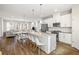 Open concept layout with kitchen island, dining area, and living room with hardwood floors at 3567 Hidden Valley Cir, Lawrenceville, GA 30044