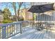 Relaxing outdoor area with a wooden deck, chairs, table, and large umbrella providing shade at 403 Oak Harbor Ct, Marietta, GA 30066
