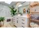 A modern bathroom featuring a white vanity, a soaking tub, and abundant natural light from a skylight at 403 Oak Harbor Ct, Marietta, GA 30066