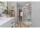 Modern bathroom with glass-enclosed shower, white marbled tiles, wood accents, and contemporary fixtures at 403 Oak Harbor Ct, Marietta, GA 30066