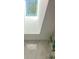 Bright bathroom featuring a skylight, marble tiles, and a decorative plant at 403 Oak Harbor Ct, Marietta, GA 30066