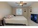 Cozy bedroom featuring a ceiling fan, window with natural light, and a view of the backyard at 403 Oak Harbor Ct, Marietta, GA 30066
