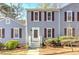 Charming townhouse exterior with gray siding and a cozy front entrance, complimented by lush green bushes at 403 Oak Harbor Ct, Marietta, GA 30066