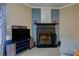 Close-up view of a fireplace with TV and decor on the mantle in the living room at 403 Oak Harbor Ct, Marietta, GA 30066
