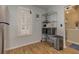 This kitchen eating area features sleek wood-look flooring, white window shutters, and a steel shelving unit for storage at 403 Oak Harbor Ct, Marietta, GA 30066
