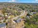 An aerial view showing a brick home nestled in a well-maintained community with mature trees and winding roads at 4437 Blue Ridge Dr, Douglasville, GA 30135