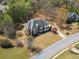 Aerial view of a brick house with landscaped grounds and mature trees at 4437 Blue Ridge Dr, Douglasville, GA 30135