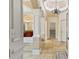 Hallway featuring decorative columns leads to a bathroom with soaking tub at 4437 Blue Ridge Dr, Douglasville, GA 30135