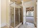 Walk-in shower features glass doors and tile surround, located off the main bedroom at 4437 Blue Ridge Dr, Douglasville, GA 30135