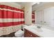 Bathroom features a shower, dark wood vanity, sink, toilet, and large mirror at 4437 Blue Ridge Dr, Douglasville, GA 30135