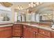 Bathroom showcasing granite countertops, wooden cabinets, and a large mirror at 4437 Blue Ridge Dr, Douglasville, GA 30135