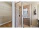 Bathroom features a walk-in shower, built in shelf and bench, and custom shelving at 4437 Blue Ridge Dr, Douglasville, GA 30135