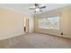 Carpeted bedroom features a trey ceiling, ceiling fan, and lots of natural light at 4437 Blue Ridge Dr, Douglasville, GA 30135