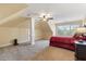 Cozy bedroom featuring a red bedspread, ceiling fan, and neutral carpeting at 4437 Blue Ridge Dr, Douglasville, GA 30135