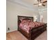 Carpeted bedroom featuring a trey ceiling, ceiling fan, and a decorative headboard at 4437 Blue Ridge Dr, Douglasville, GA 30135