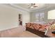 Spacious bedroom features a ceiling fan, trey ceiling, carpet, and ensuite bathroom at 4437 Blue Ridge Dr, Douglasville, GA 30135