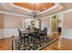 Formal dining room with chandelier and decorative ceiling at 4437 Blue Ridge Dr, Douglasville, GA 30135
