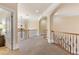 Upstairs hallway with arches and a wrought iron railing at 4437 Blue Ridge Dr, Douglasville, GA 30135