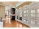 Bright hallway with hardwood floors, a built-in cabinet, and elegant French doors at 4437 Blue Ridge Dr, Douglasville, GA 30135