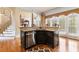 Kitchen island with stainless steel dishwasher near an elegant staircase and dining area at 4437 Blue Ridge Dr, Douglasville, GA 30135
