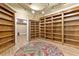 Home library featuring custom built-in bookshelves, hardwood floors and a decorative rug at 4437 Blue Ridge Dr, Douglasville, GA 30135