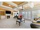 Large living room with a fireplace, built-in shelving, a coffered ceiling, and multiple windows at 4437 Blue Ridge Dr, Douglasville, GA 30135